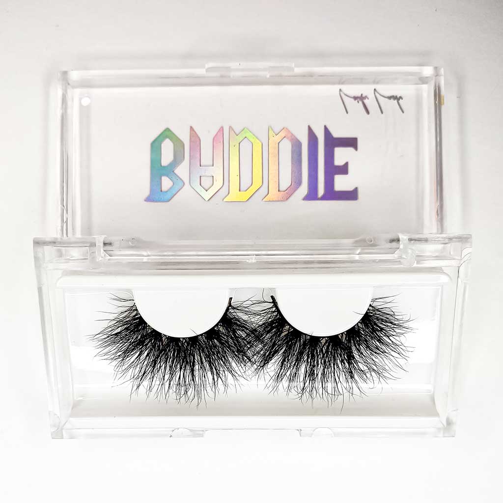 Bold mink baddie eyelashes sitting inside their plastic carrying case.