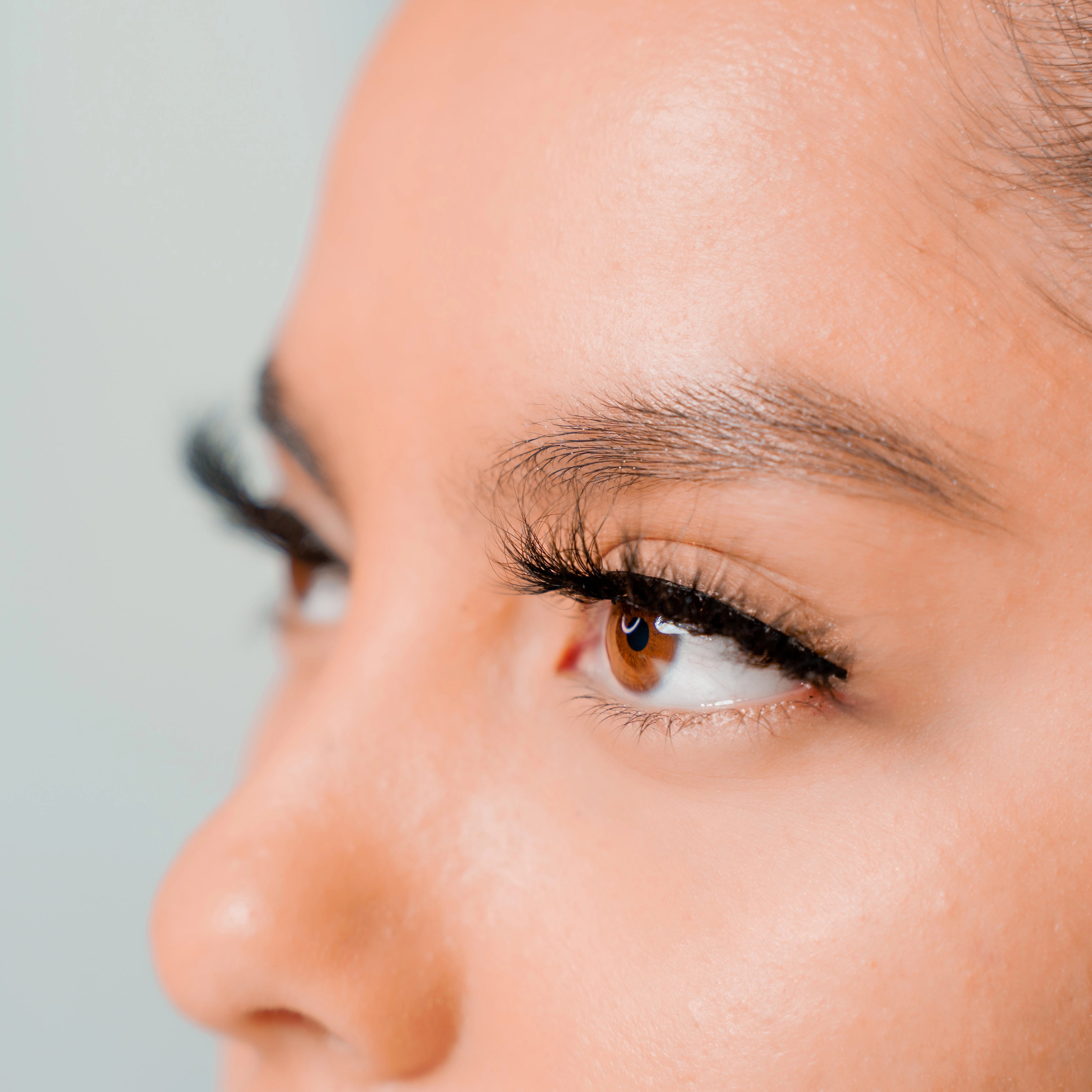 side view of busty lashes on woman with brown eyes
